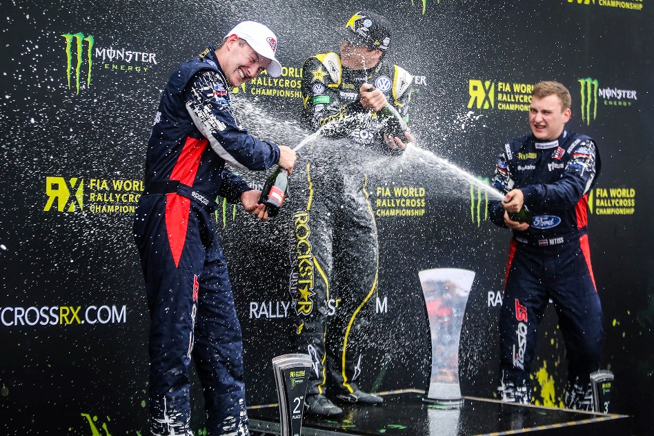The Ford drivers Bakkerud and Nitišs while showering VW campaigner Foust with champain. © OMSE/QNIGAN/ERC24